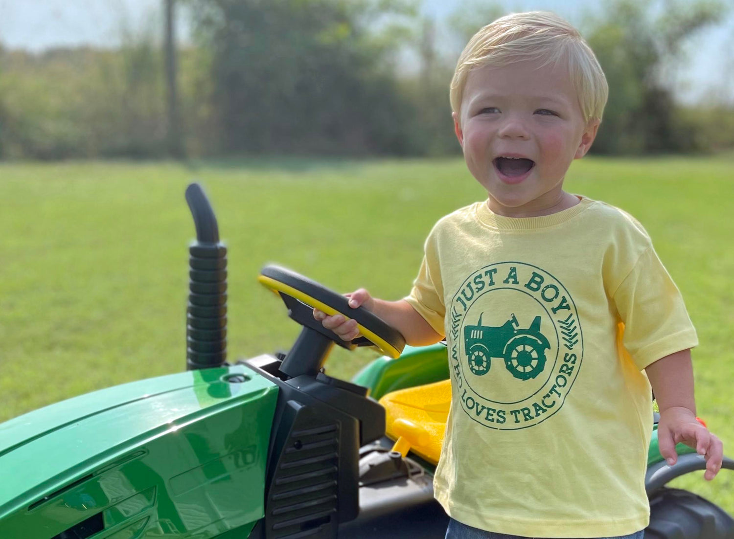 Oh Boy! Tees Just a Boy Who Loves Tractors yellow and green graphic tee shirt is available in yellow, blue, and navy with a green silk screen design. Soft cotton fabric makes this the perfect tee shirt for your busy little boy. 